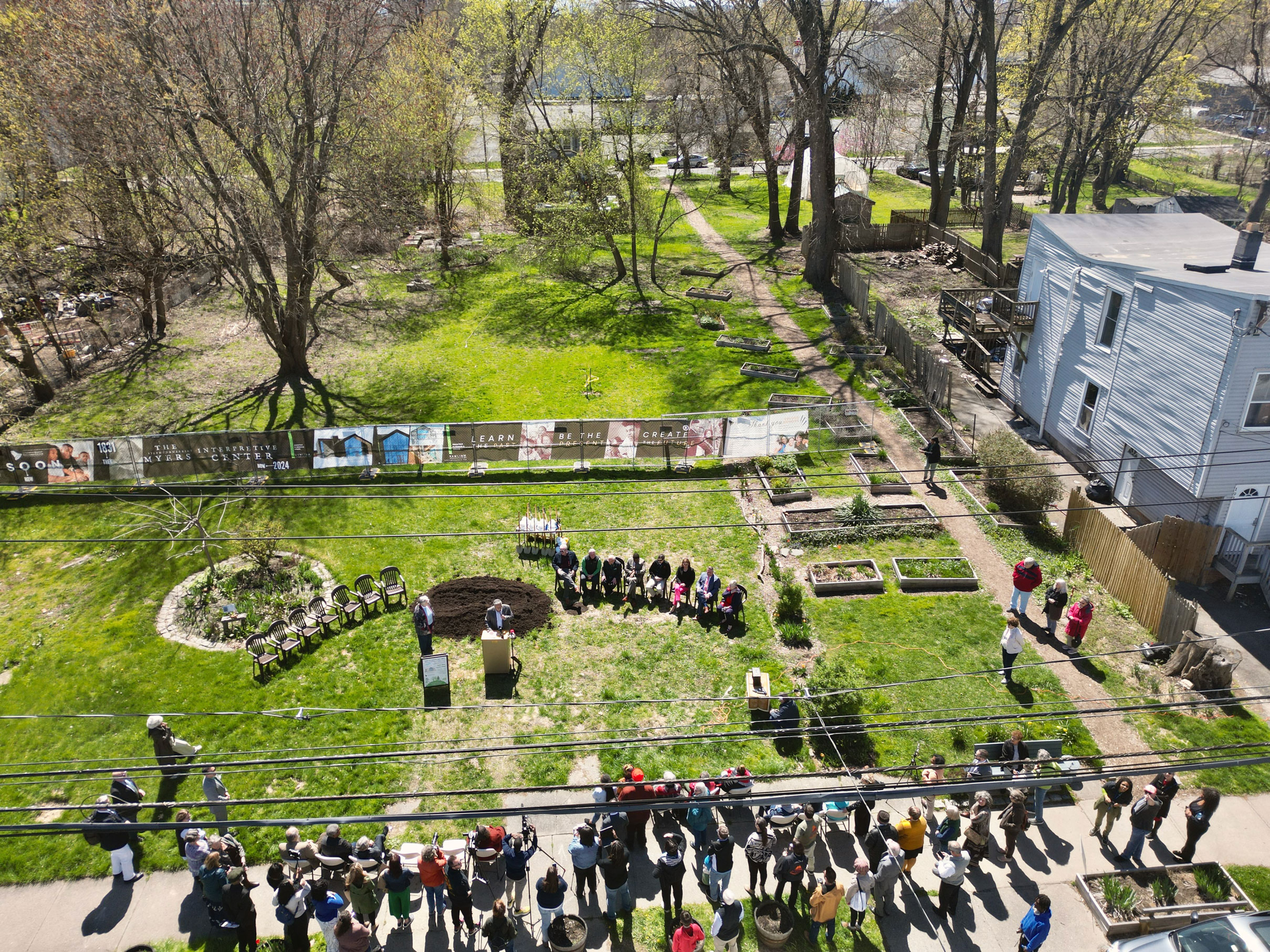 A drone photo of the groundbreaking ceremony for the Underground Railroad Interpretive Center. The UREC owns 196 Livingston and the string of properties where the new interpretive center will eventually be built (184-190 Livingston Avenue). Two properties directly to the south of the Myers Residence, 97 and 99 3rd Street, are also owned by UREC. The blue house directly to the west (192 Livingston Avenue) of the new center is privately owned. The Stephen and Harriet Myers Residence is located next to the blue house, at 194 Livingston Avenue, and is just out of frame. Photo courtesy of Daniel Hurtt.