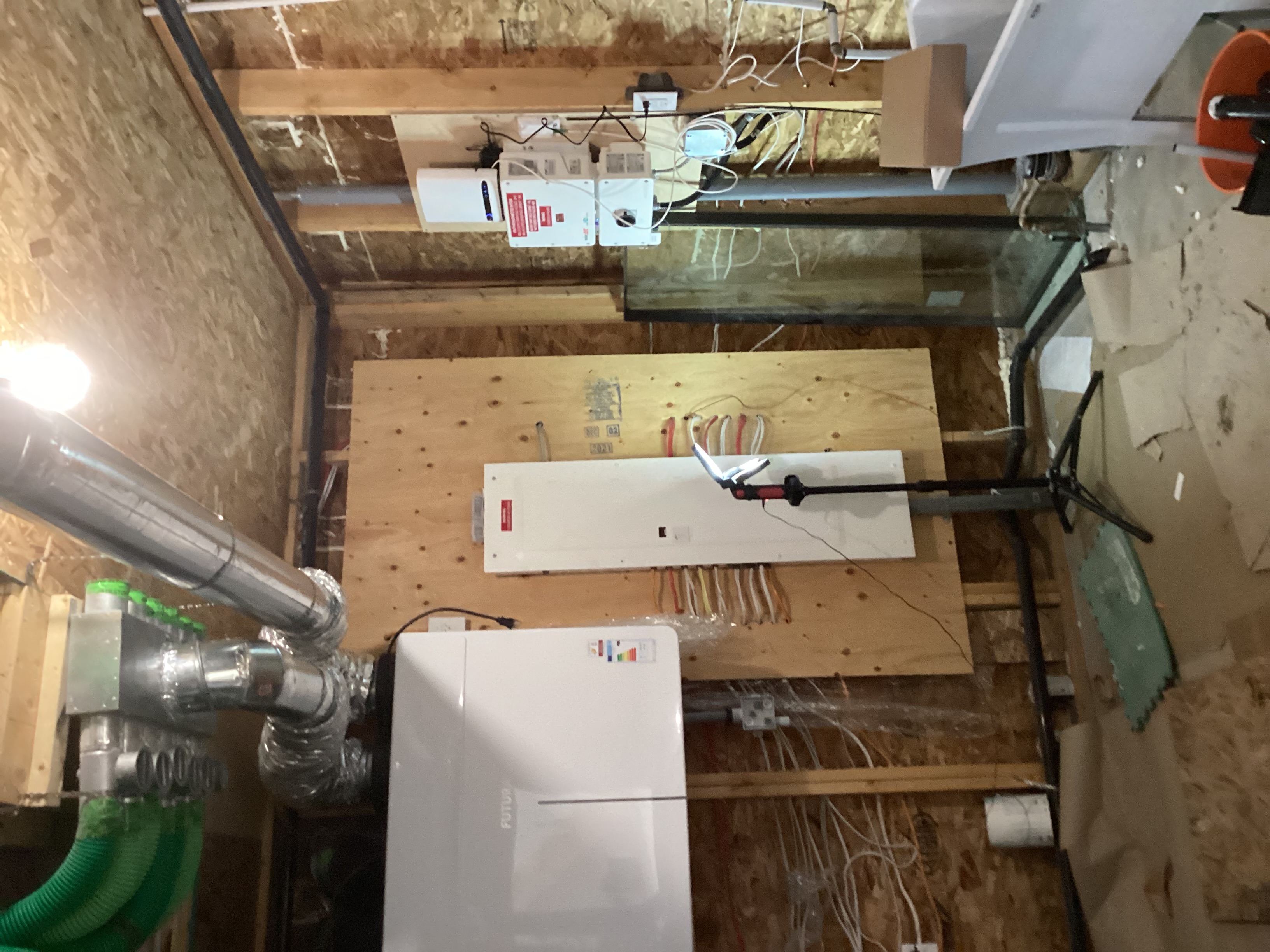 The mechanical room showing Jablatron ERV and Solaredge inverter before interior insulation