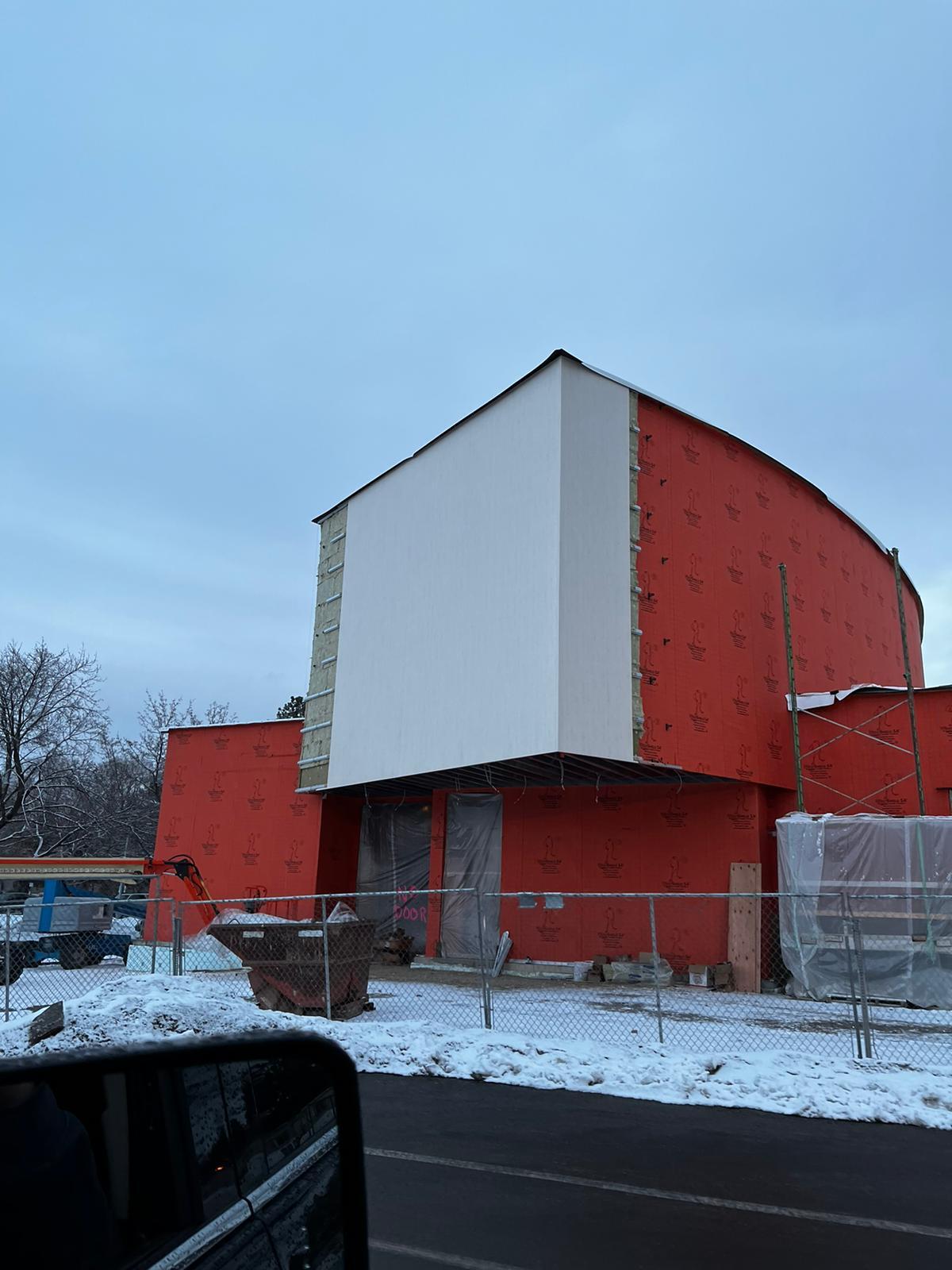 Peeling away the facade reveals the WRB, insulation, and girt assemblies.