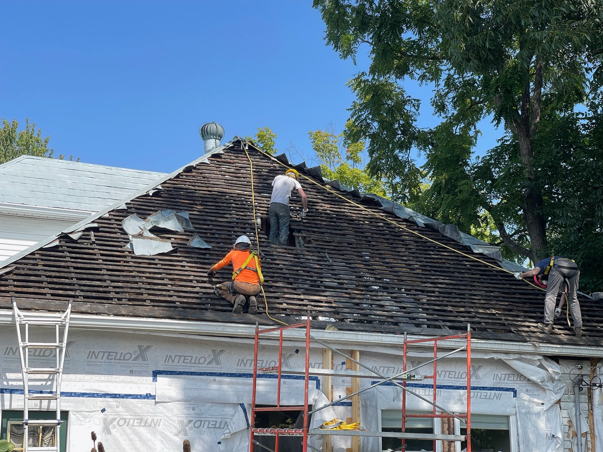 The team exposes the skeleton of the roof structure after removing the chimney.